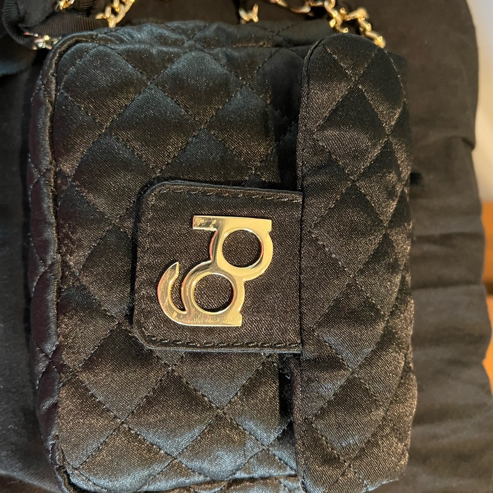 Purificación García black crossbody mini bag with an embellished cord.